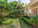 Spacious backyard with a manicured lawn, mature trees, and lush landscaping offering a serene outdoor space at 2927 W Bayshore Ct, Tampa, FL 33611