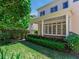 Beautiful backyard showcasing lush greenery, well-maintained lawn, privacy fence and covered patio at 2927 W Bayshore Ct, Tampa, FL 33611