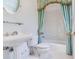 Traditional bathroom featuring a pedestal sink and decorative curtained tub at 2927 W Bayshore Ct, Tampa, FL 33611