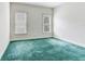 Spacious bedroom with carpet, two windows, and neutral walls at 2927 W Bayshore Ct, Tampa, FL 33611