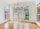Bright dining room featuring hardwood floors, large windows, and an elegant chandelier at 2927 W Bayshore Ct, Tampa, FL 33611