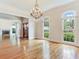 Elegant dining room with hardwood floors and chandelier flows into a bright living room with fireplace at 2927 W Bayshore Ct, Tampa, FL 33611