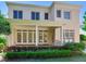 Inviting home exterior featuring a covered porch, multi-pane doors, manicured landscaping and multiple windows at 2927 W Bayshore Ct, Tampa, FL 33611