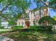 Elegant two-story home boasting a landscaped front yard, complemented by mature trees and a charming architectural design at 2927 W Bayshore Ct, Tampa, FL 33611
