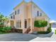 Stucco home featuring a private entrance and well maintained landscaping at 2927 W Bayshore Ct, Tampa, FL 33611