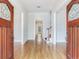 Spacious foyer featuring gleaming hardwood floors, arched doorways, and a staircase with decorative runner at 2927 W Bayshore Ct, Tampa, FL 33611
