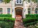 Elegant front entrance with a beautiful wood door, enhanced by sidelights and lush landscaping at 2927 W Bayshore Ct, Tampa, FL 33611