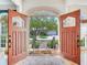 Grand foyer entrance with double doors offering a view of the beautifully landscaped front yard at 2927 W Bayshore Ct, Tampa, FL 33611