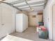 Clean garage interior with two refrigerators, built-in shelving and ample storage space at 2927 W Bayshore Ct, Tampa, FL 33611