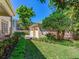 Detached two car garage featuring a manicured lawn and partial view of home's exterior at 2927 W Bayshore Ct, Tampa, FL 33611