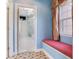 Bright hallway with a window seat and view into the primary bathroom featuring a glass shower at 2927 W Bayshore Ct, Tampa, FL 33611