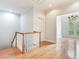 Bright hallway with wood floors, white trim, and a view of the chandelier room at 2927 W Bayshore Ct, Tampa, FL 33611