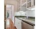 Kitchenette features stone countertops, modern appliances, and custom cabinetry for a sleek design at 2927 W Bayshore Ct, Tampa, FL 33611