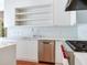 Contemporary kitchen with white cabinets, stainless steel appliances, and open shelving at 2927 W Bayshore Ct, Tampa, FL 33611