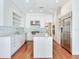 Modern kitchen featuring stainless steel appliances, a large island, and sleek white cabinetry at 2927 W Bayshore Ct, Tampa, FL 33611