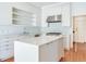 Bright kitchen featuring stainless steel appliances, light blue backsplash, and a center island at 2927 W Bayshore Ct, Tampa, FL 33611