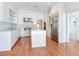 Stylish kitchen features white cabinetry, quartz counters, stainless appliances, and hardwood floors at 2927 W Bayshore Ct, Tampa, FL 33611