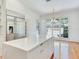 Close-up of kitchen island, with lots of drawers and storage, and a stainless refrigerator to the left at 2927 W Bayshore Ct, Tampa, FL 33611