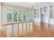 Bright living room featuring hardwood floors, built-in shelving, and French doors to the backyard at 2927 W Bayshore Ct, Tampa, FL 33611
