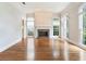 Bright living room features fireplace, large windows, and hardwood floors offering a comfortable space at 2927 W Bayshore Ct, Tampa, FL 33611