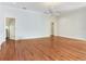 Spacious living room with hardwood floors, white walls, crown molding, and a ceiling fan at 2927 W Bayshore Ct, Tampa, FL 33611