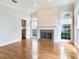 Bright living room features fireplace, large windows, and hardwood floors; kitchen is visible at 2927 W Bayshore Ct, Tampa, FL 33611