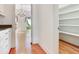 Pantry with custom shelving offers ample storage space; a dining room is visible at 2927 W Bayshore Ct, Tampa, FL 33611
