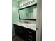Modern bathroom with a marble countertop, a large mirror, and green walls at 3001 58Th Ave S # 1103, St Petersburg, FL 33712