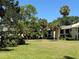 Well-maintained lawn with mature trees and landscaping in a quiet residential community, under a clear blue sky at 3001 58Th Ave S # 1103, St Petersburg, FL 33712