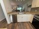 Updated kitchen showcasing stainless steel appliances, granite countertops and white cabinetry at 3001 58Th Ave S # 1103, St Petersburg, FL 33712