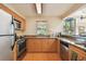 Bright kitchen with stainless steel appliances, light wood cabinets, and granite countertops at 3001 58Th Ave S # 1103, St Petersburg, FL 33712