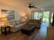 Well-lit living room showcasing comfortable seating and access to an outdoor patio at 3001 58Th Ave S # 1103, St Petersburg, FL 33712