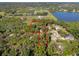 Aerial view of the property, showcasing its wooded surroundings, nearby lake, farmland, and defined property lines at 308 N Smokey Mountain Rd, Seffner, FL 33584