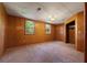 Standard bedroom with carpet flooring, wood paneled walls, two windows and closet at 308 N Smokey Mountain Rd, Seffner, FL 33584