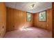 Bedroom featuring wood paneling and natural light from the two windows at 308 N Smokey Mountain Rd, Seffner, FL 33584
