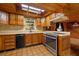 Functional kitchen with wooden cabinetry, laminate countertops, stainless steel range, and a light-filled window at 308 N Smokey Mountain Rd, Seffner, FL 33584