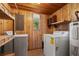 Laundry room with washer, dryer, sink, wood paneled walls, and window at 308 N Smokey Mountain Rd, Seffner, FL 33584