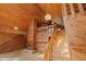 Stairway with lights and wood-paneled walls featuring a cozy fireplace and open staircase leading to upper levels at 308 N Smokey Mountain Rd, Seffner, FL 33584