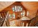 The vaulted living room has multiple windows, wood paneling, and an open staircase, creating a bright and airy atmosphere at 308 N Smokey Mountain Rd, Seffner, FL 33584
