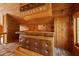 Alternate close up view of wet bar area featuring brown leather, wood paneling, and overhead lighting at 308 N Smokey Mountain Rd, Seffner, FL 33584