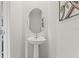 Stylish powder room featuring a sleek pedestal sink and contemporary decor at 3138 Victoria Inlet Dr, Holiday, FL 34691