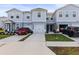 Charming townhomes featuring attached garages, well-maintained lawns, and modern architectural details at 3138 Victoria Inlet Dr, Holiday, FL 34691