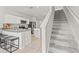 Modern kitchen with stainless steel appliances, a breakfast bar, and easy access to the stairs at 3138 Victoria Inlet Dr, Holiday, FL 34691