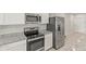 Modern kitchen featuring stainless steel appliances, granite countertops, and white cabinets for stylish cooking at 3138 Victoria Inlet Dr, Holiday, FL 34691