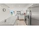 Bright, open-concept kitchen featuring granite countertops, stainless steel appliances, and backyard view at 3138 Victoria Inlet Dr, Holiday, FL 34691