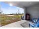 Covered patio with modern grill, outdoor seating, and expansive backyard view at 3138 Victoria Inlet Dr, Holiday, FL 34691