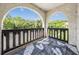 A private balcony offers a view of the surrounding trees and green space at 320 N Bayshore Blvd # 208, Clearwater, FL 33759