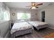 Sunlit bedroom featuring two cozy beds, light wood flooring, and ample natural light from the large windows at 320 N Bayshore Blvd # 208, Clearwater, FL 33759