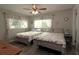 Comfortable bedroom featuring two beds, light gray walls, and a ceiling fan, with natural light through the windows at 320 N Bayshore Blvd # 208, Clearwater, FL 33759