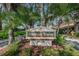 Harbour Towne Condominiums community sign surrounded by lush greenery and swaying palm trees at 320 N Bayshore Blvd # 208, Clearwater, FL 33759